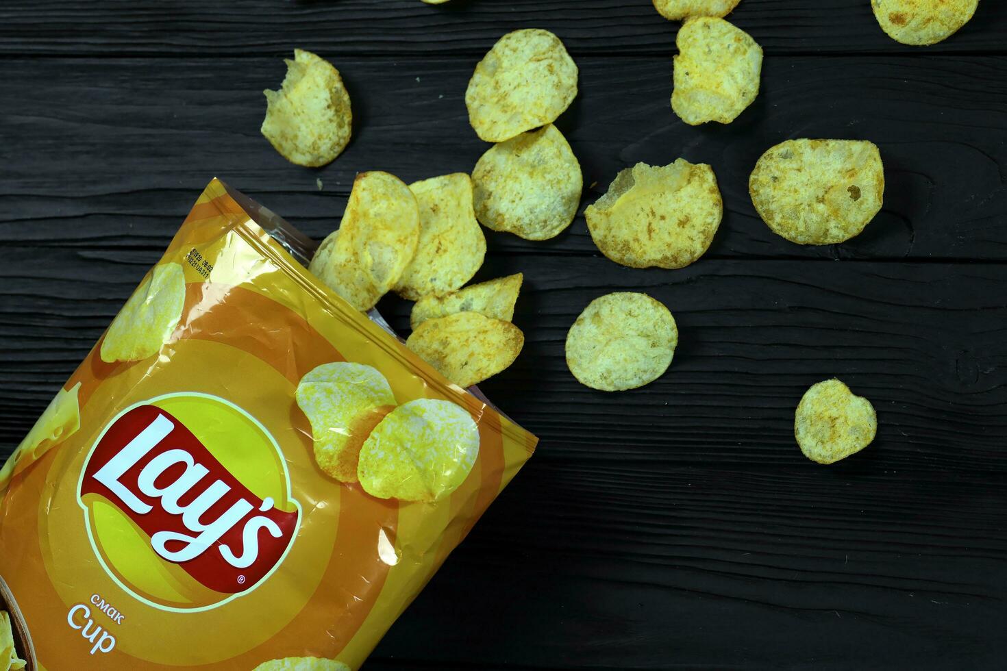 KHARKOV, UKRAINE - JANUARY 3, 2021 Lays potato chips with cheese flavour and original lays logo in middle of package. Worldwide famous brand of potato chips photo