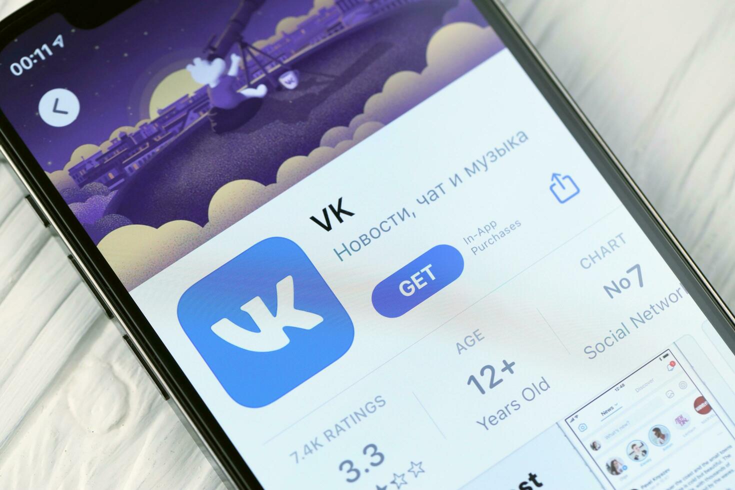 KHARKOV, UKRAINE - MARCH 5, 2021 VK icon and application from App store on iPhone 12 pro display screen on white table photo