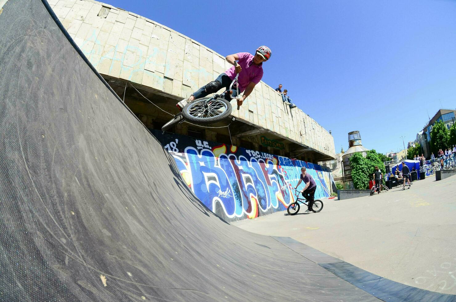 KHARKIV, UKRAINE - 27 MAY, 2018 Freestyle BMX riders in a skatepark during the annual festival of street cultures photo