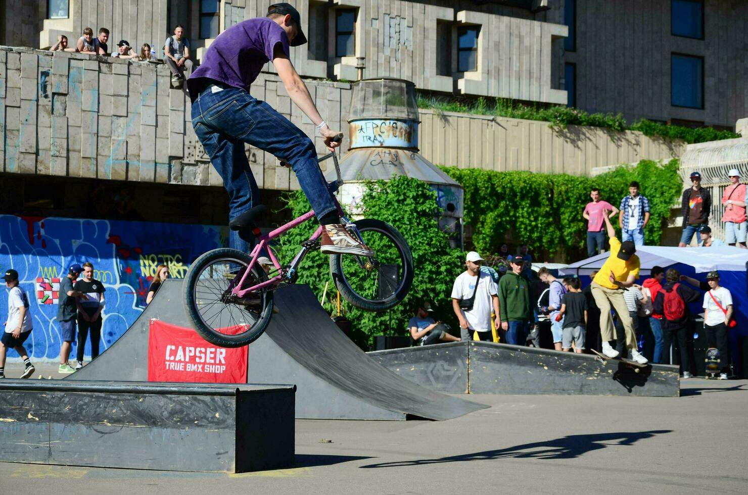 KHARKIV, UKRAINE - 27 MAY, 2018 Freestyle BMX riders in a skatepark during the annual festival of street cultures photo