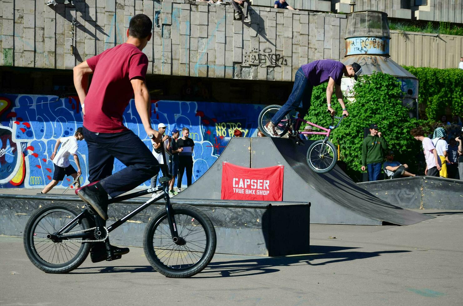 KHARKIV, UKRAINE - 27 MAY, 2018 Freestyle BMX riders in a skatepark during the annual festival of street cultures photo