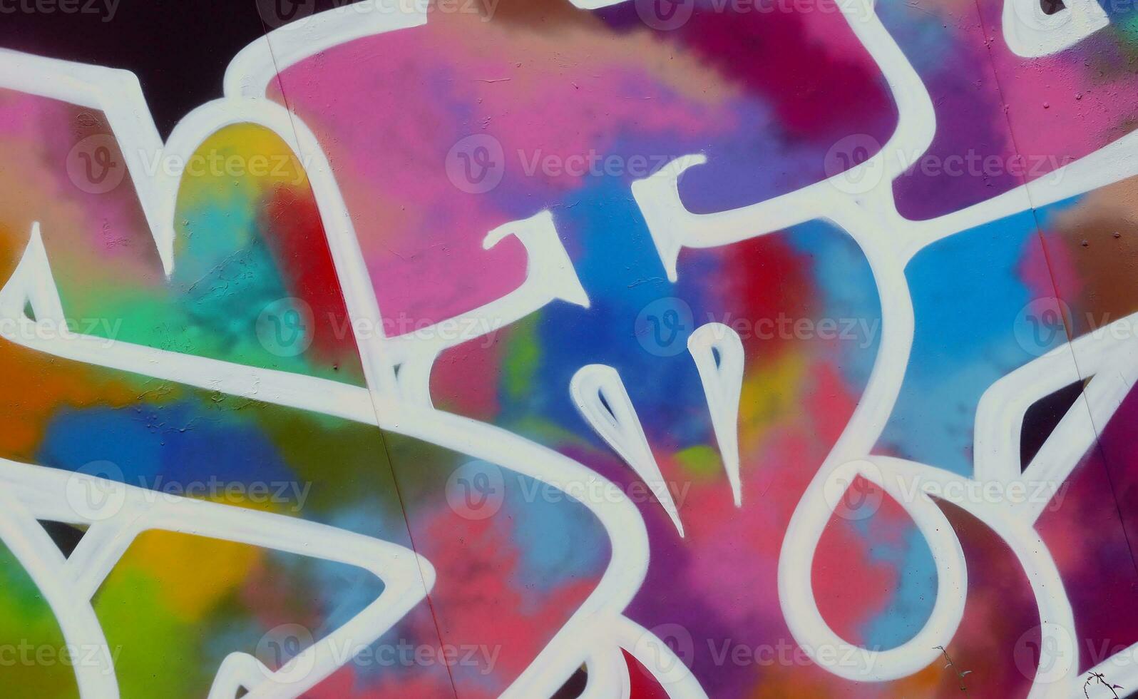 Colorful background of graffiti painting artwork with bright aerosol strips on metal wall photo