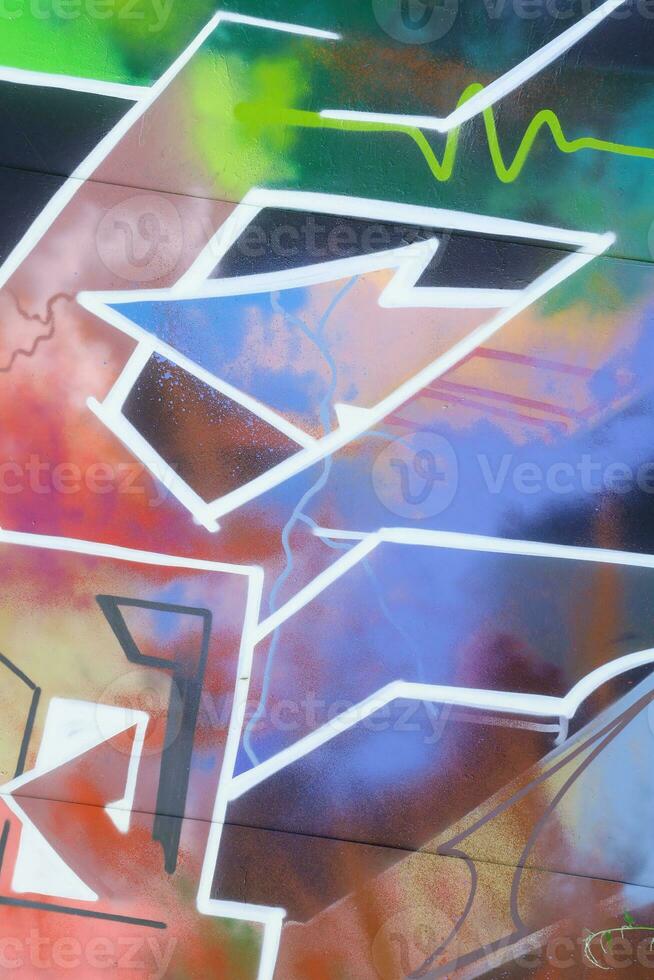 Colorful background of graffiti painting artwork with bright aerosol strips on metal wall photo