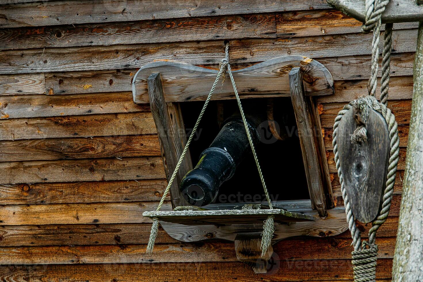 black cannon in the side of a wooden vintage warship background photo