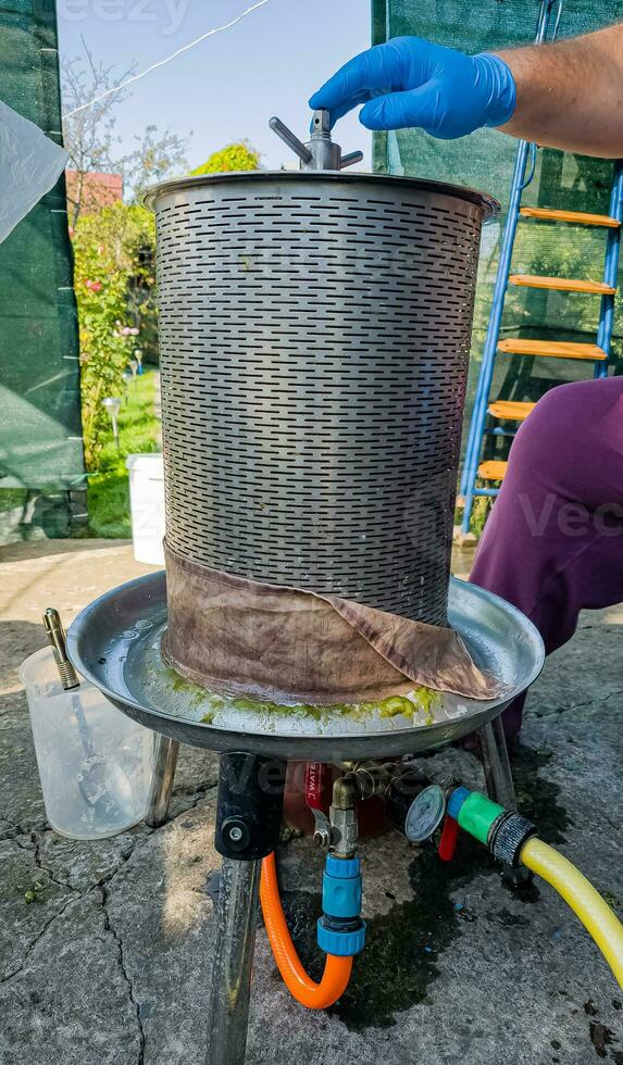 The process of making homemade grape wine. The operation of a hydraulic press to obtain grape juice for fermentation. photo