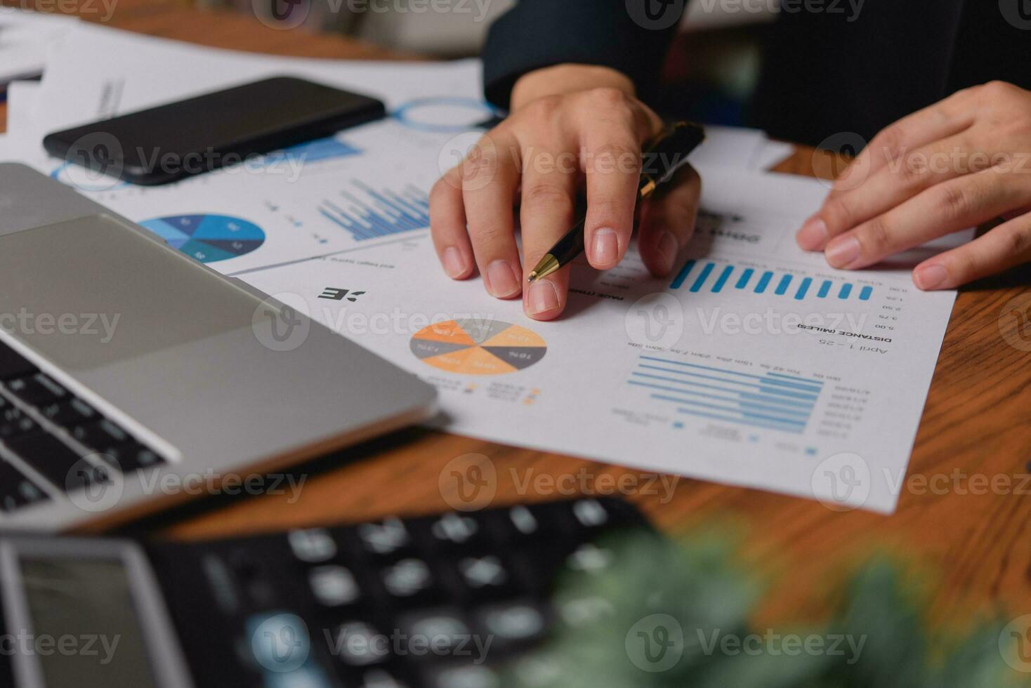businessman working accountant document graph and chart on desk using calculator for calculate finance report in office. photo