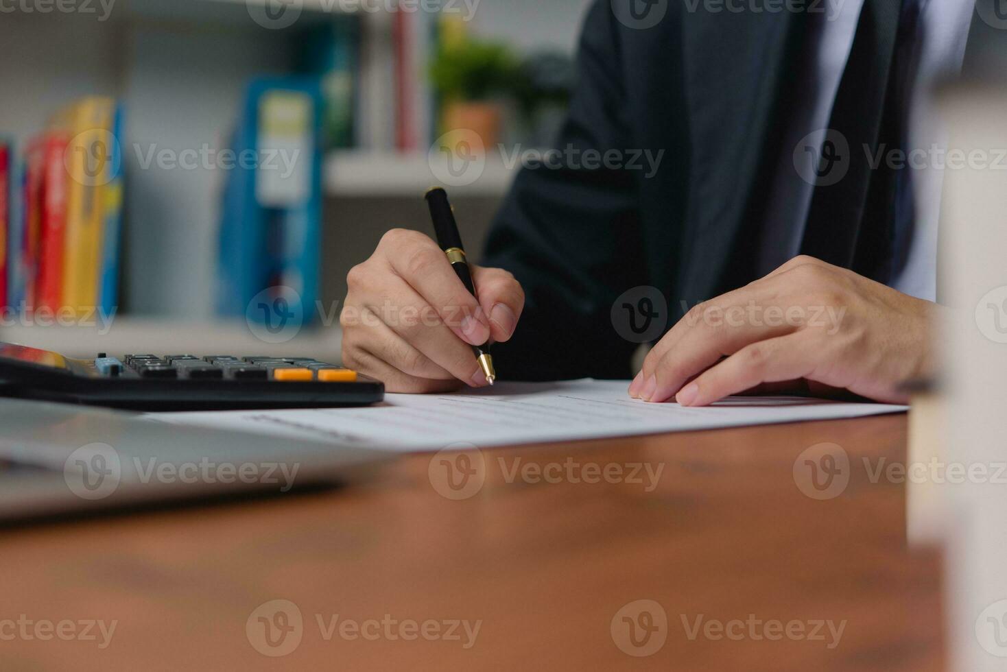 person document writing on paper with a pen, Man worker signing job contract, note, insurance and report concept. photo