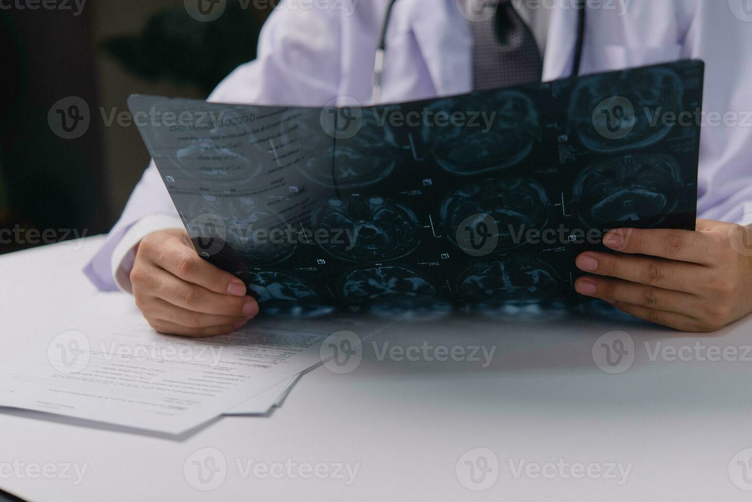 Doctor holding x ray film before surgery. MRI and CT scan examining at diagnosing patient health with radiological for medical healthcare photo