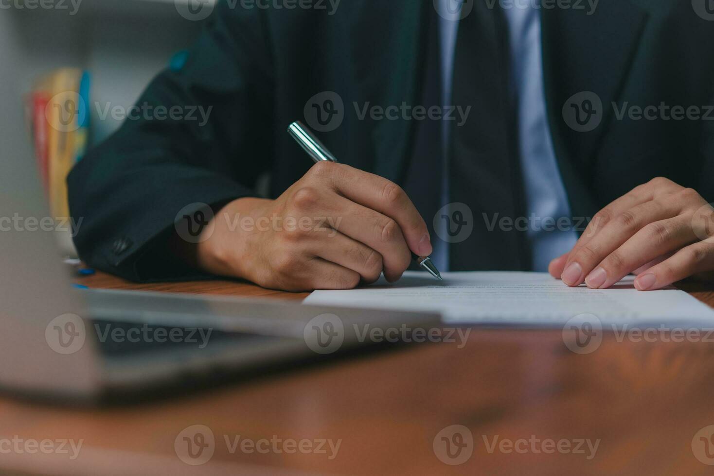 person document writing on paper with a pen, Man worker signing job contract, note, insurance and report concept. photo