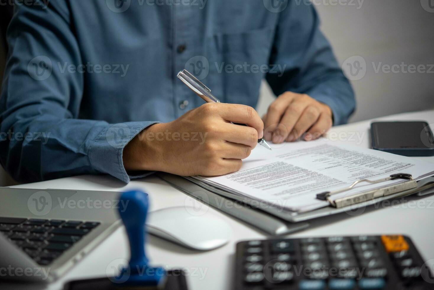 Business person Writing contract law and paper work for business and finance investments , write document, complete job application forms concept. photo