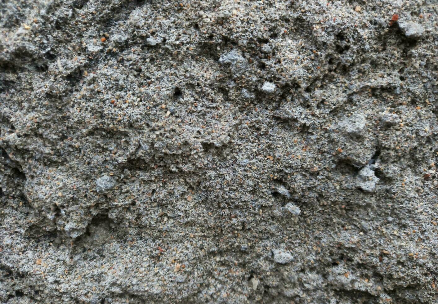 close up of texture of a gray stone wall,a very rough surface of wall of house made from cement, Close up texture of concrete wall, rough texture of gray wall in the yard, Closeup of textured wall photo