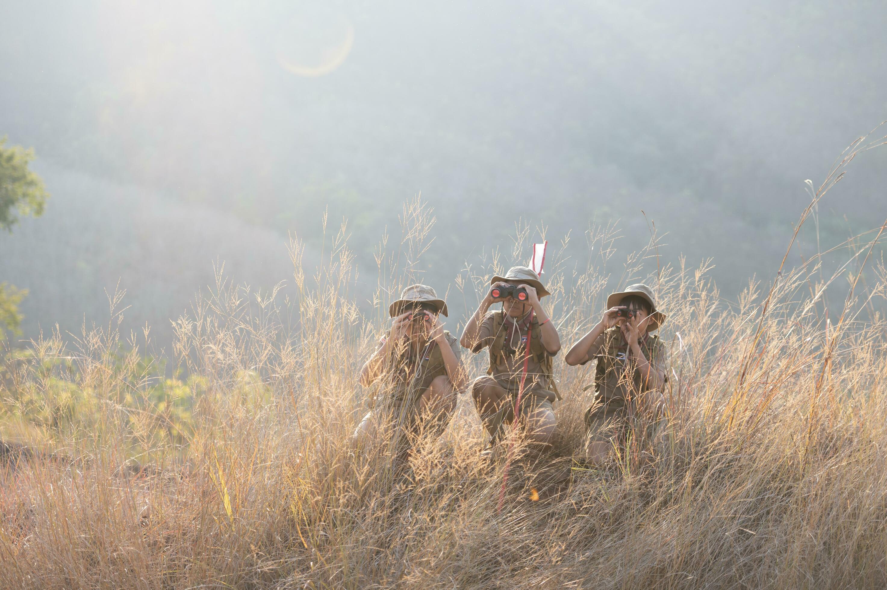 Boy Scouts team climbing with backpacks standing on mountain Boy Scouts