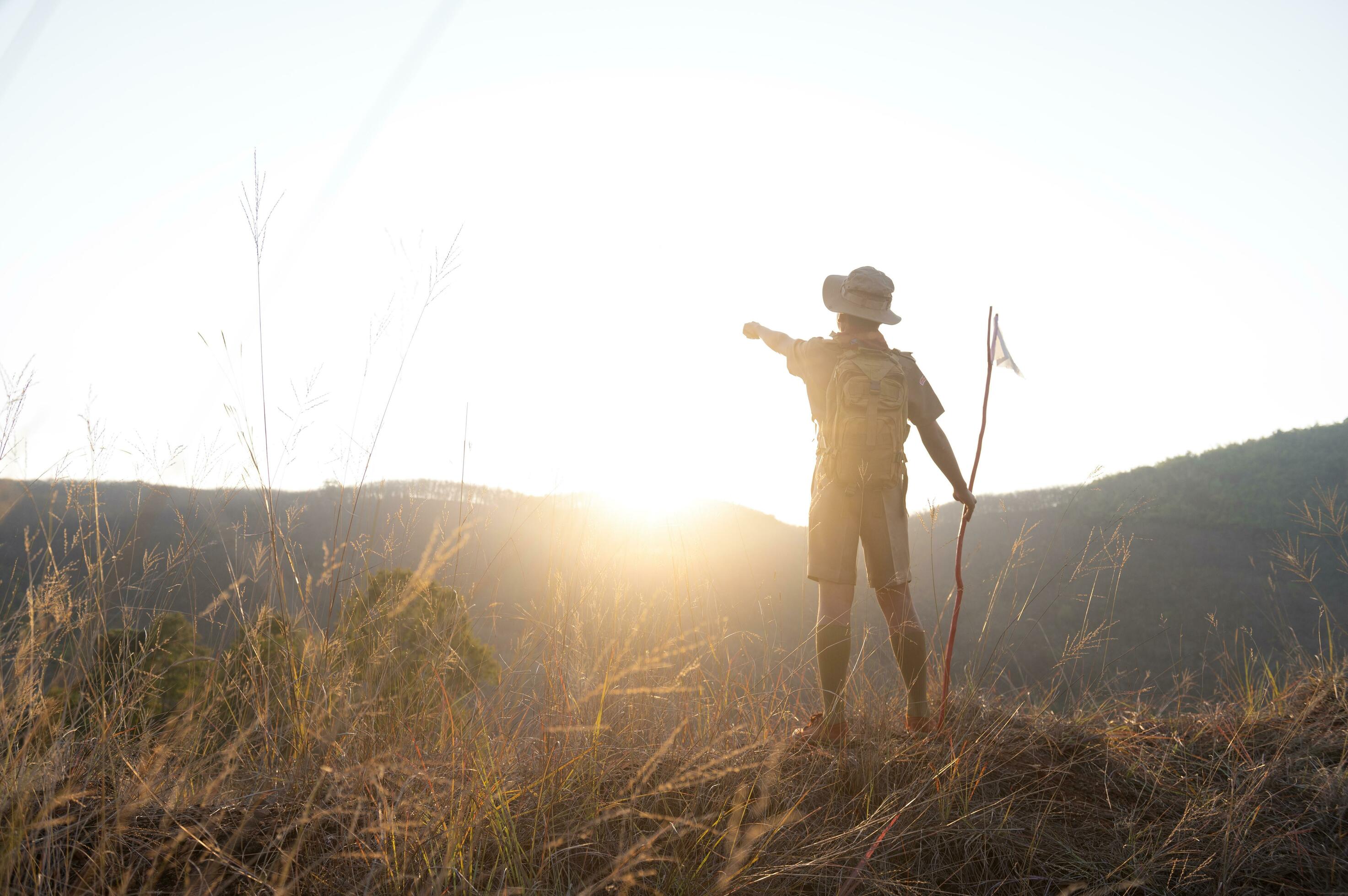 Boy Scouts team climbing with backpacks standing on mountain Boy Scouts
