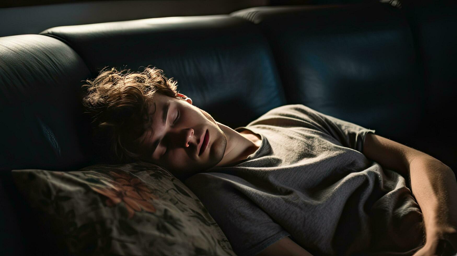Young man sleeping on sofa at home photo
