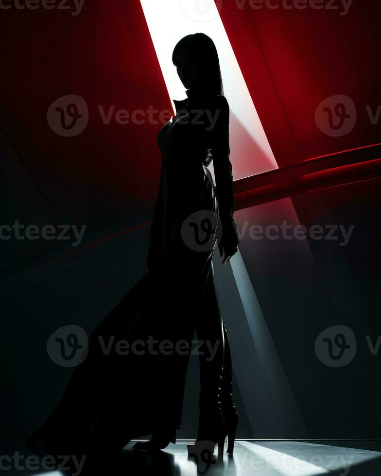 a woman in a black dress standing in front of a red light photo