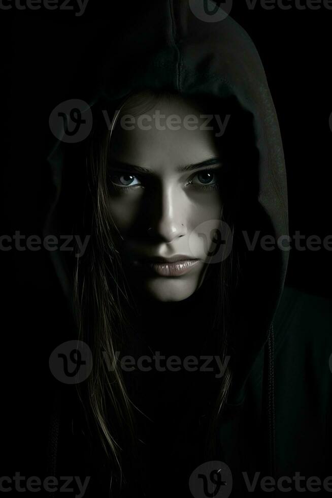 a woman in a black hoodie with blue eyes photo