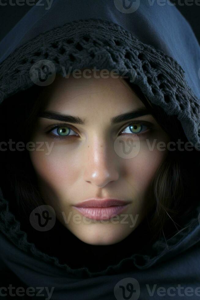 a woman in a hooded robe with green eyes generative ai photo