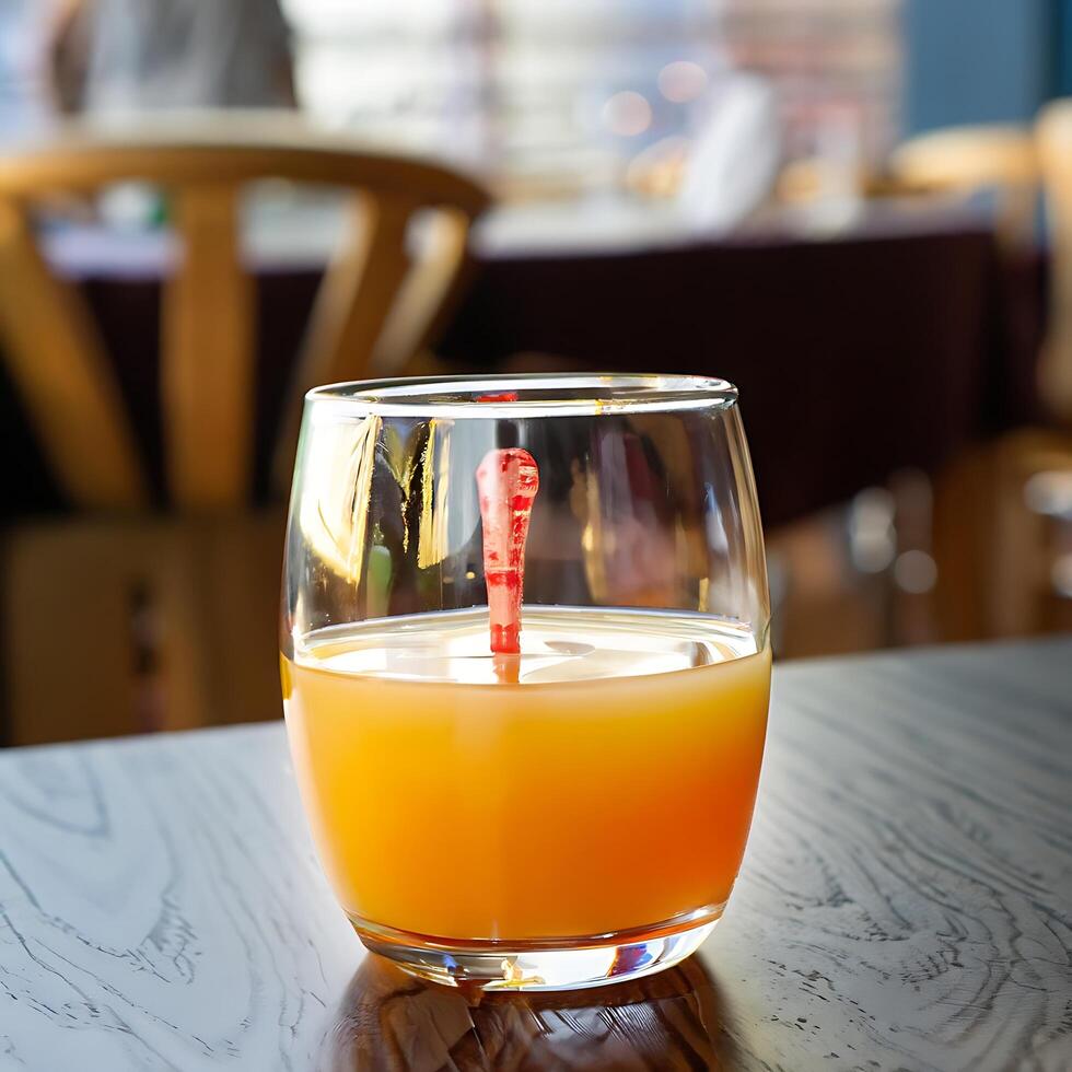 A glass of orange juice on the table - photo