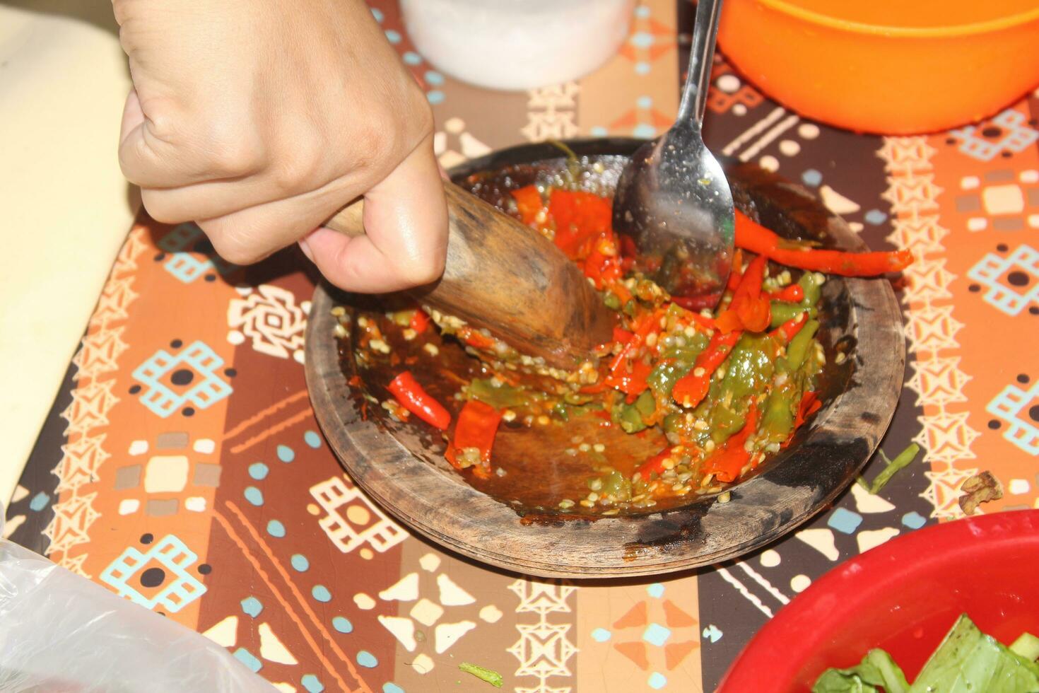 hands are grinding chilies, kneading chilies complete with chilies photo