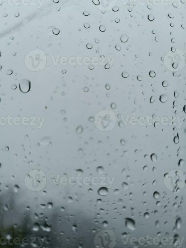 gotas de lluvia salpicaduras en el ventana cristal foto