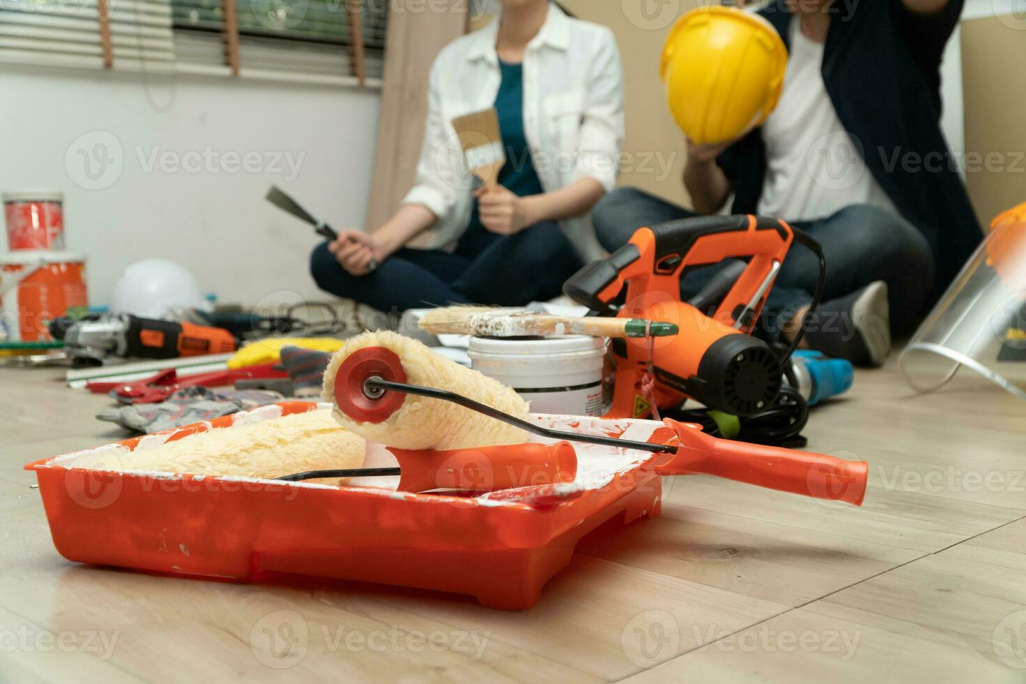 Happy Creative young Asian couple renovating house together and using a blueprint for renovation planning and how to   decorate and arrange the furniture on their new living room space photo