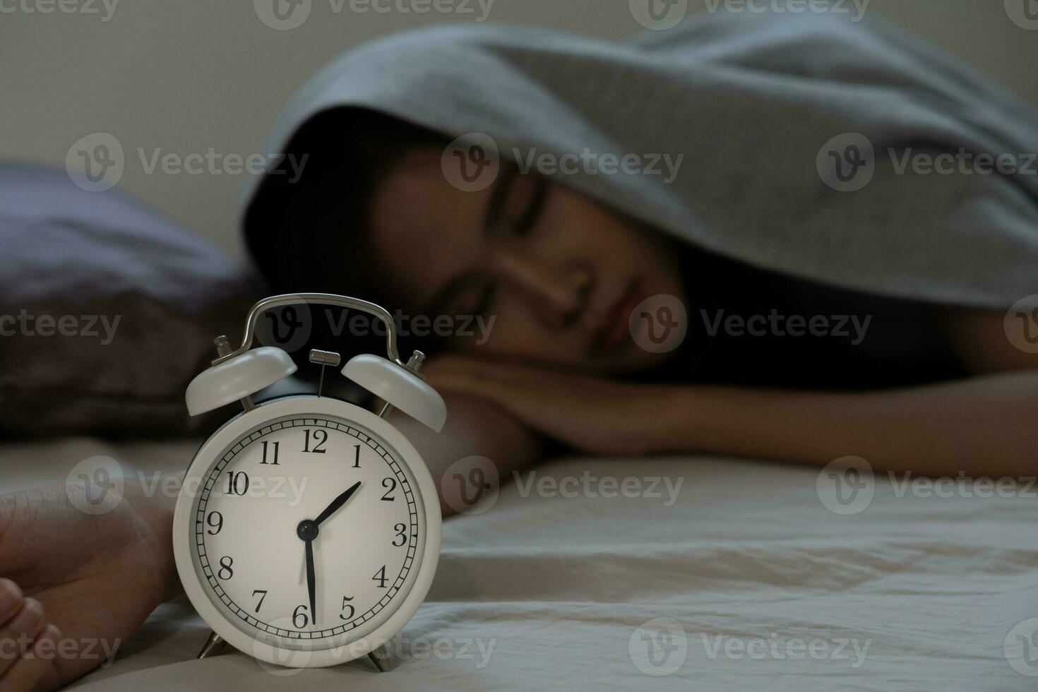 asian woman in bed late trying to sleep suffering insomnia, sleepless or scared in a nightmare, looking sad worried and stressed. Tired and headache or migraine waking up in the middle of the night. photo