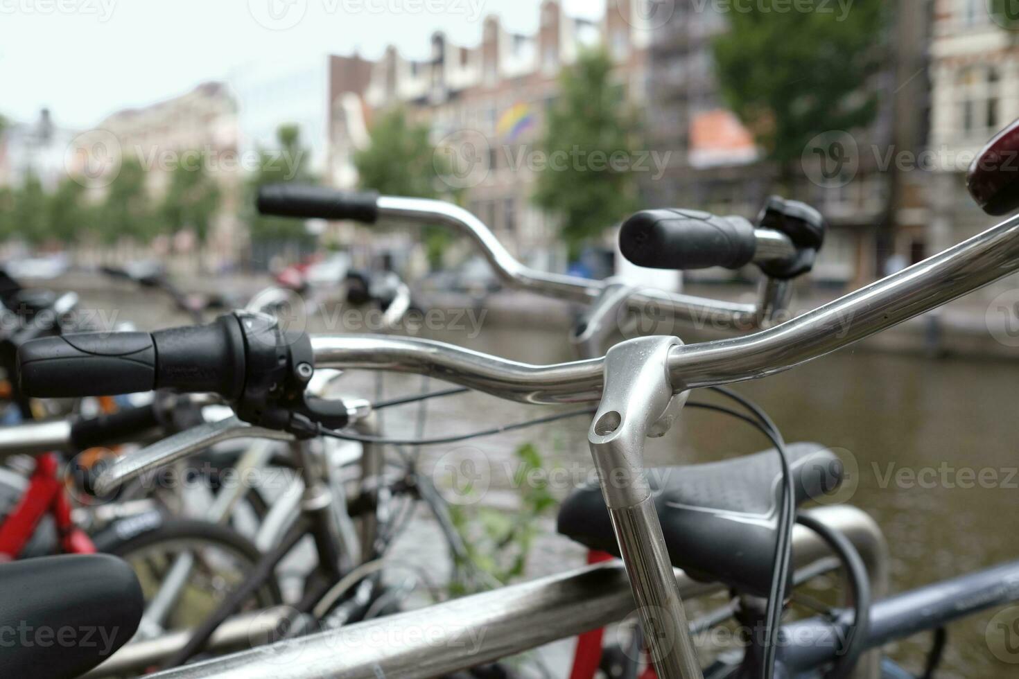 Row of bicycles in Amsterdam, Netherlands, next to the water photo