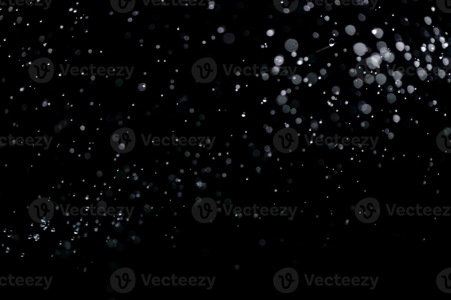 small drops of rain, snow on a black background. wind. Natural background photo