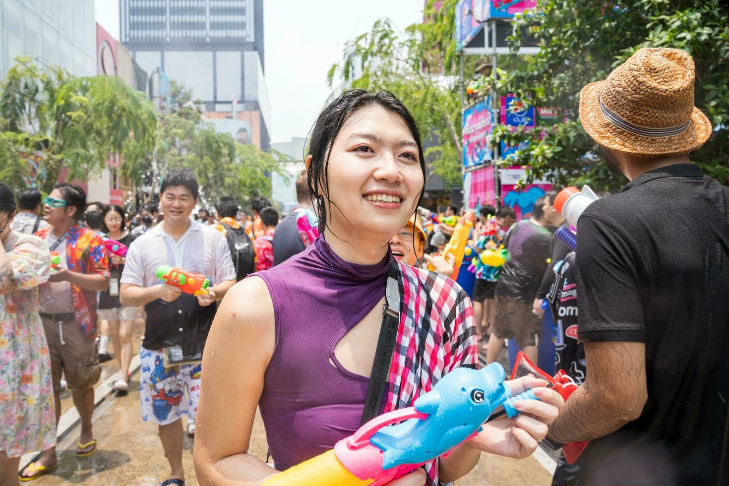Siam Square, Bangkok, Thailand - APR 13, 2023 Songkran Festival, The short action of people joins celebrations of the Thai New Year or Songkran in Siam Square Bangkok, Thailand. photo