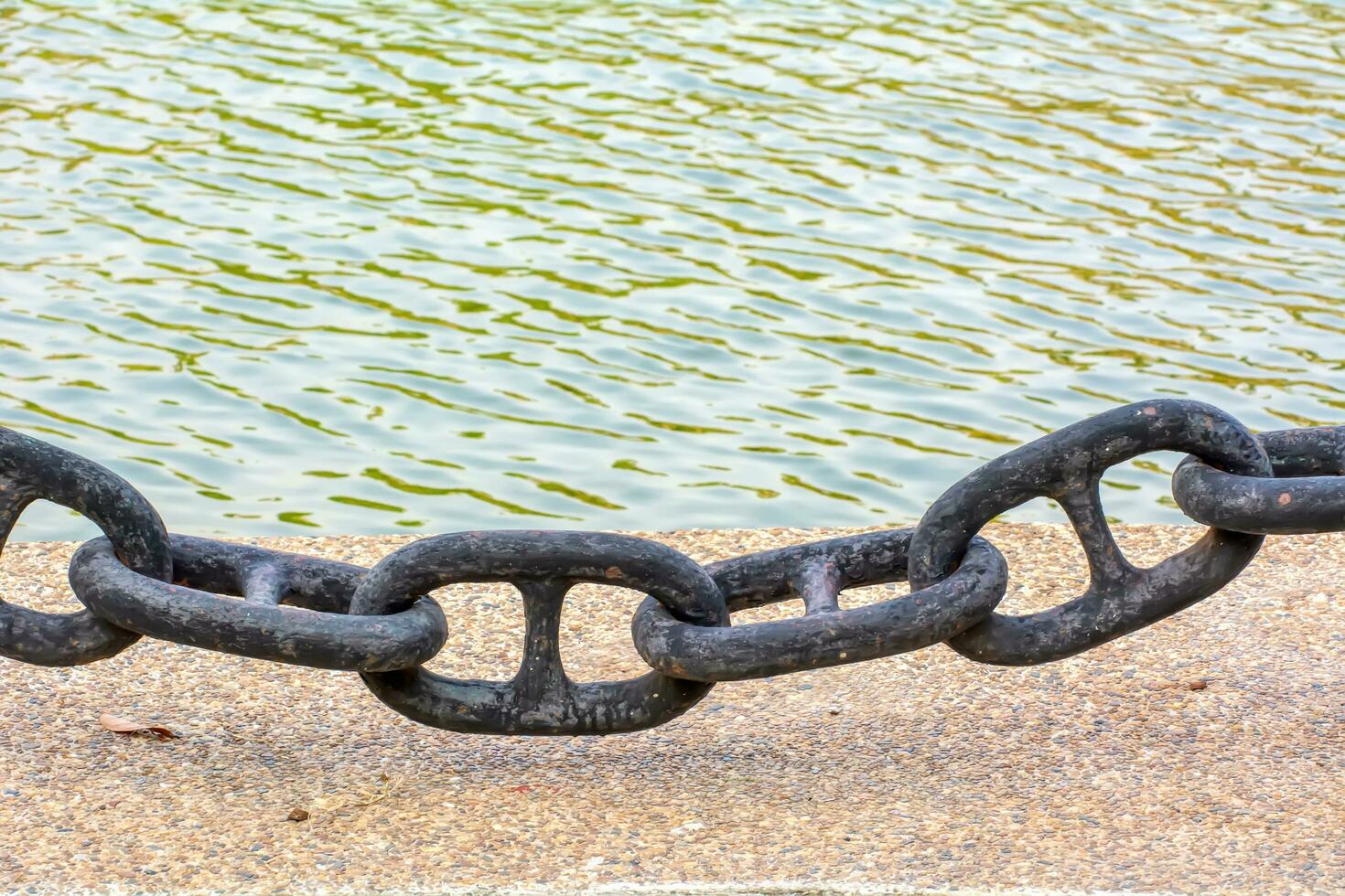 A large chain to prevent the car from falling into the water. photo