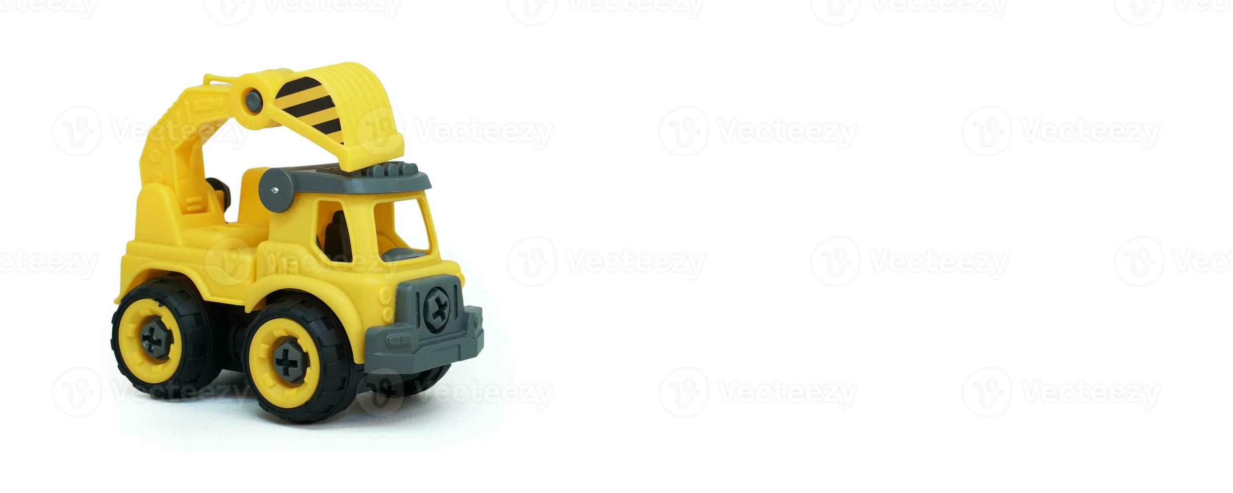 Yellow plastic truck toy isolated on white background. construction vechicle truck. a copy space for banner of toy store. photo