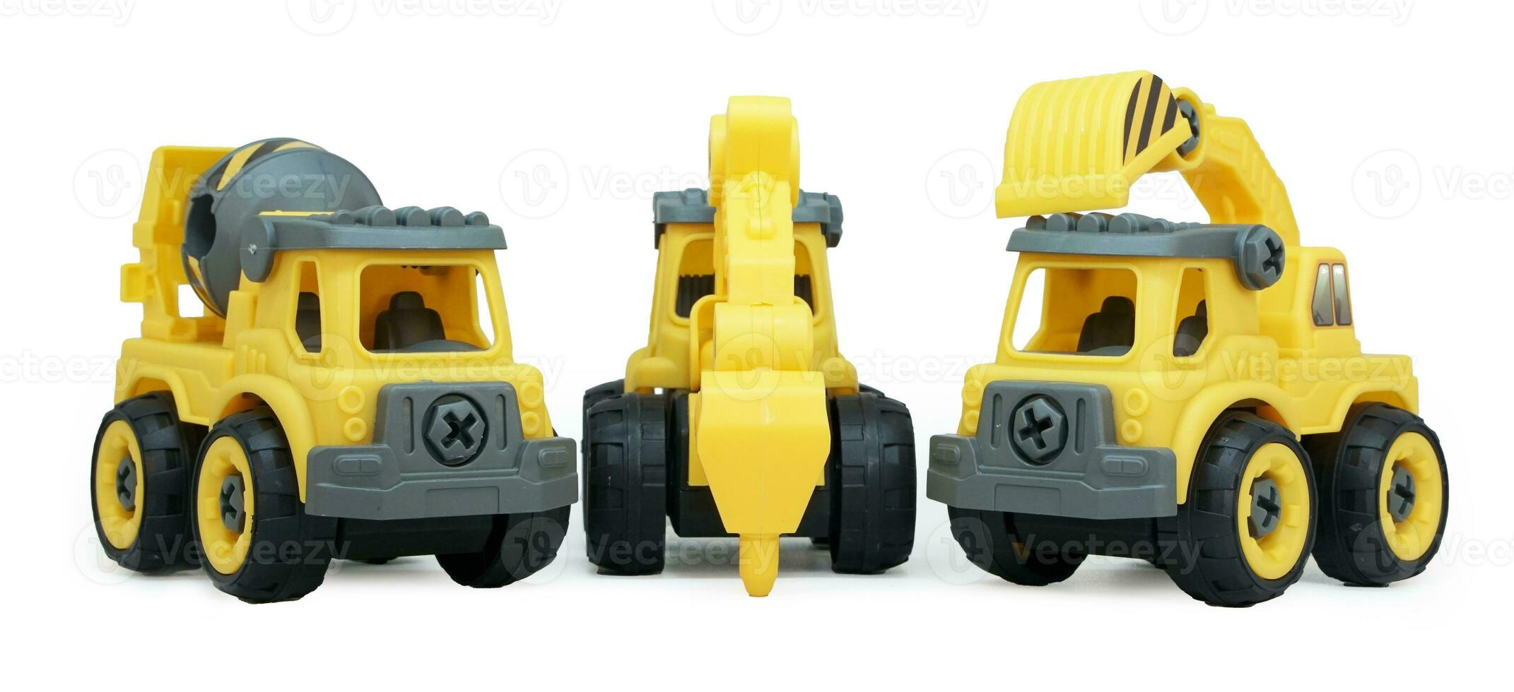 yellow plastic toy of concrete mixer and ecavator truck isolated on white background. heavy construction vehicle. low angle view photo