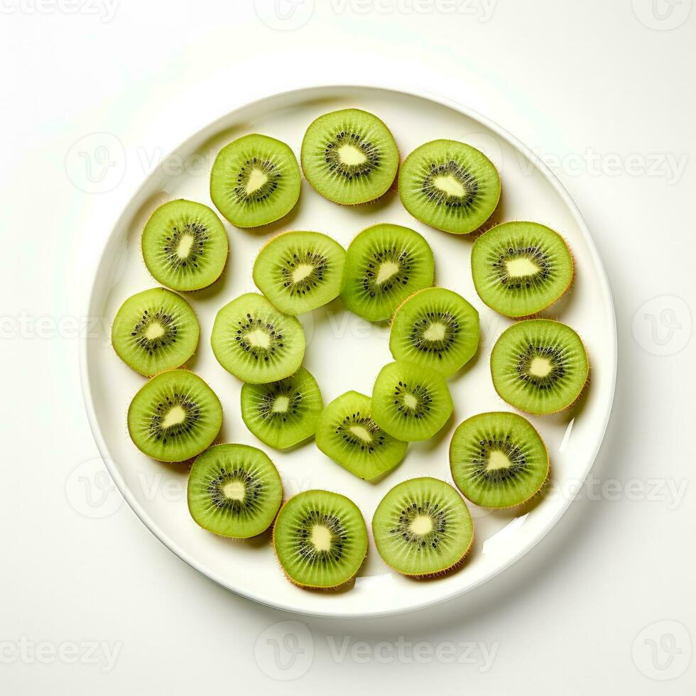 Artfully arranged array of sliced kiwi on a white plate isolated on a white background photo