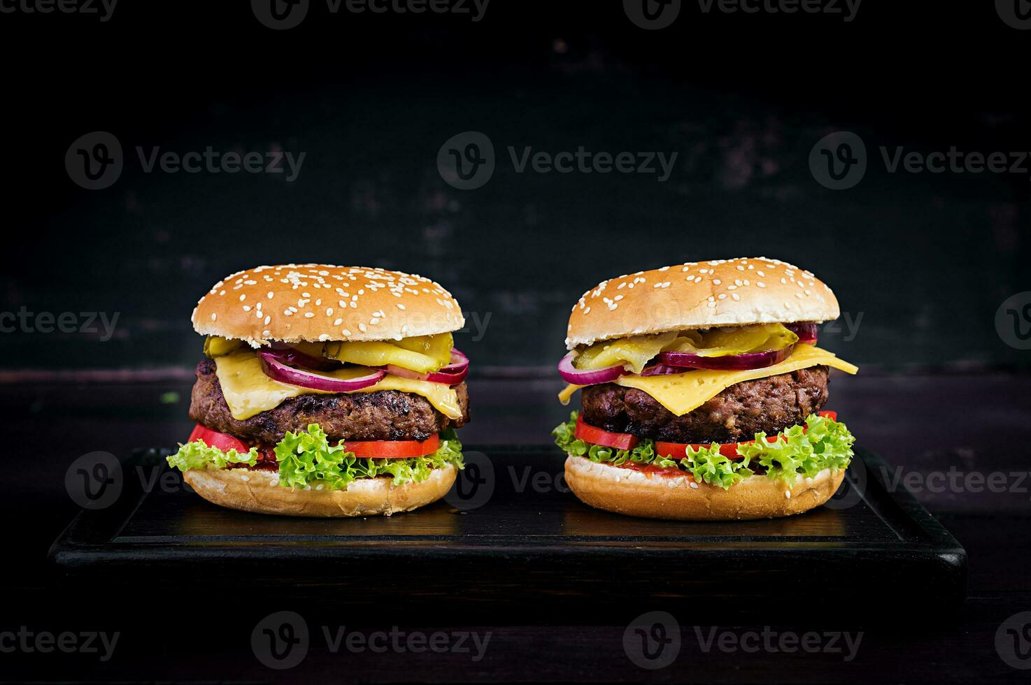 Big sandwich - hamburger burger with beef,  tomato, cheese, pickled cucumber and red onion. photo