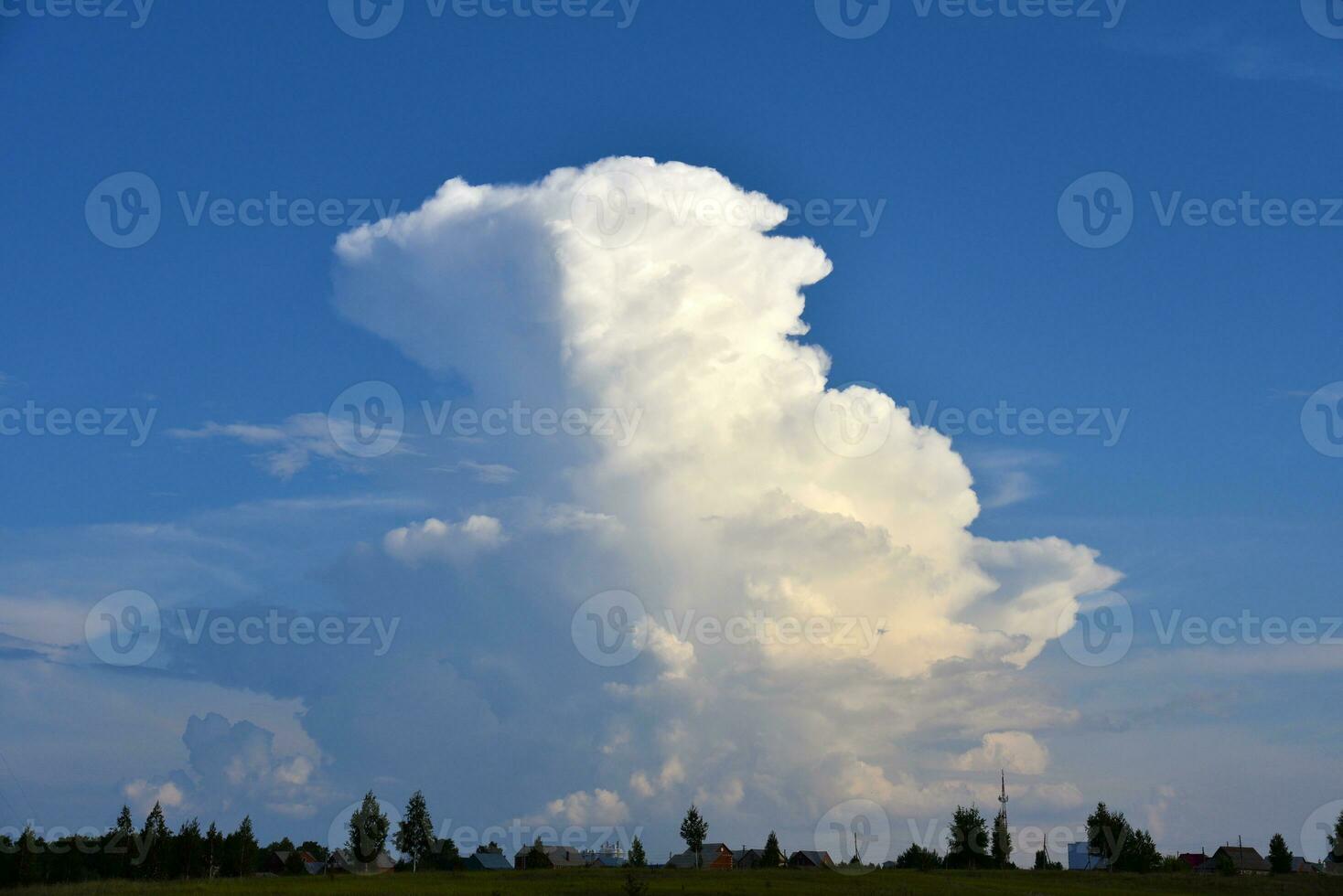 Beautiful thunderstorm landscape in the countryside. Thunderclouds and a horizon with a forest. photo