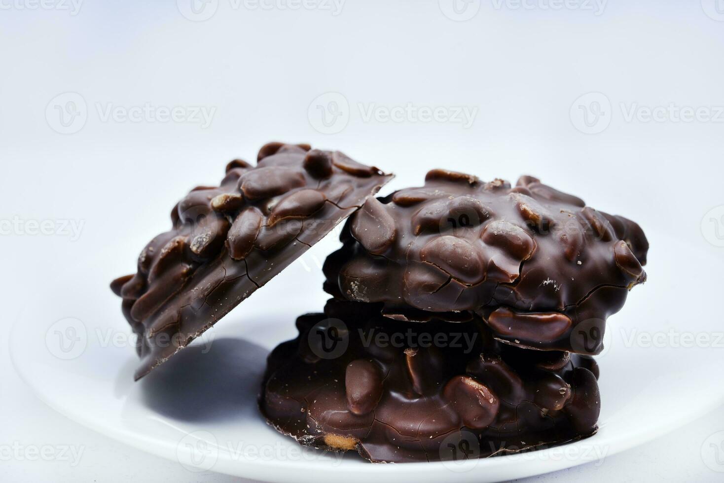 Chocolate chip cookies with nuts. Sweet appetizer on a white plate. photo