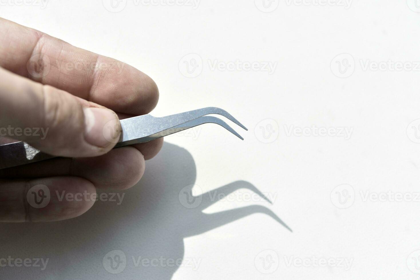 Metal tweezers. A tool for repairing electronics. photo