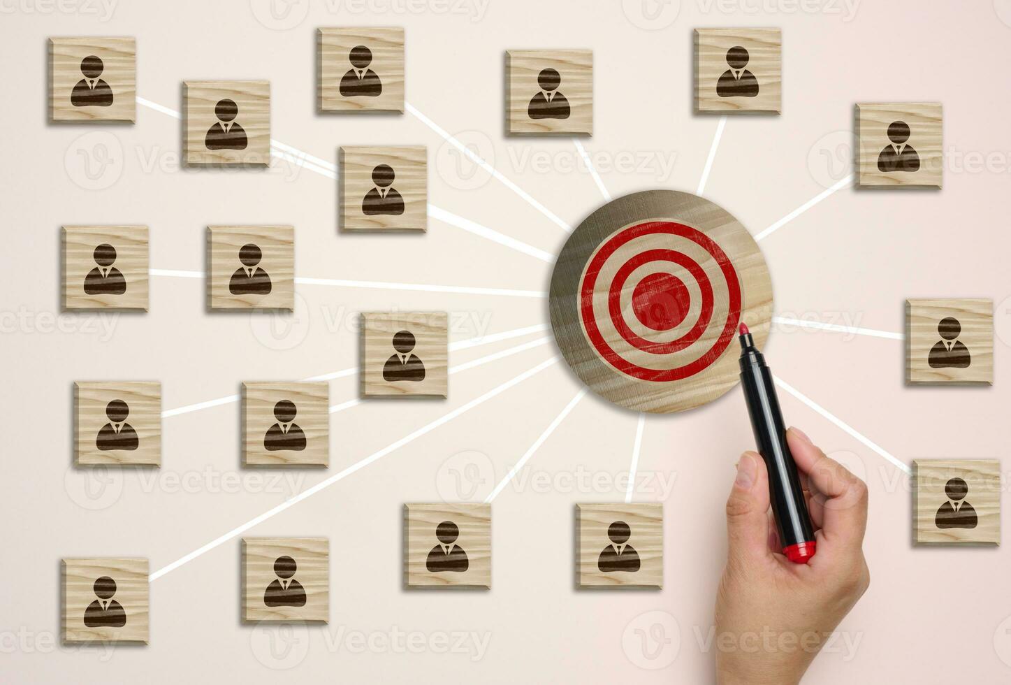 A wooden round target and wooden cubes with figure icon are connected, symbolizing the concept of target audience identification photo