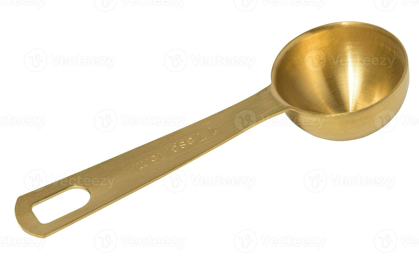 Golden metal measuring spoon for bulk and liquid products on a white isolated background, top view photo