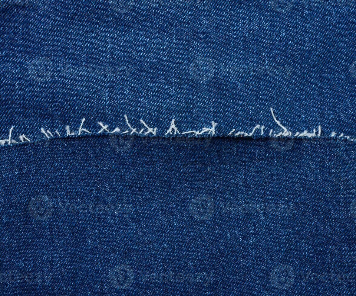 Texture of blue jeans with thread photo