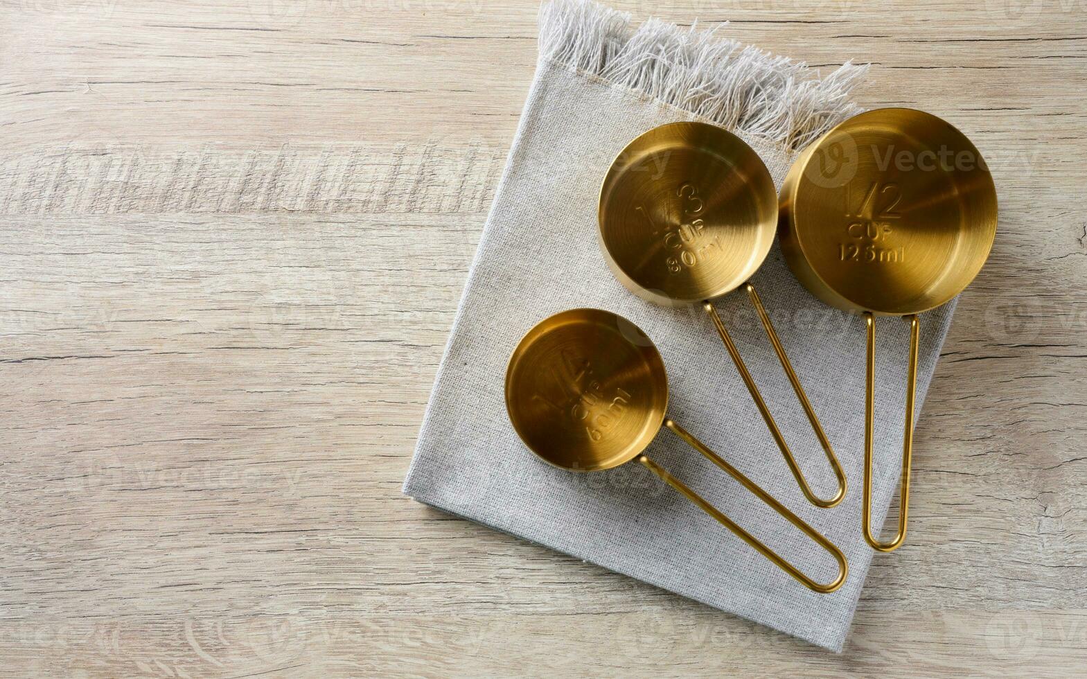 Empty measuring containers on a wooden table, top view photo