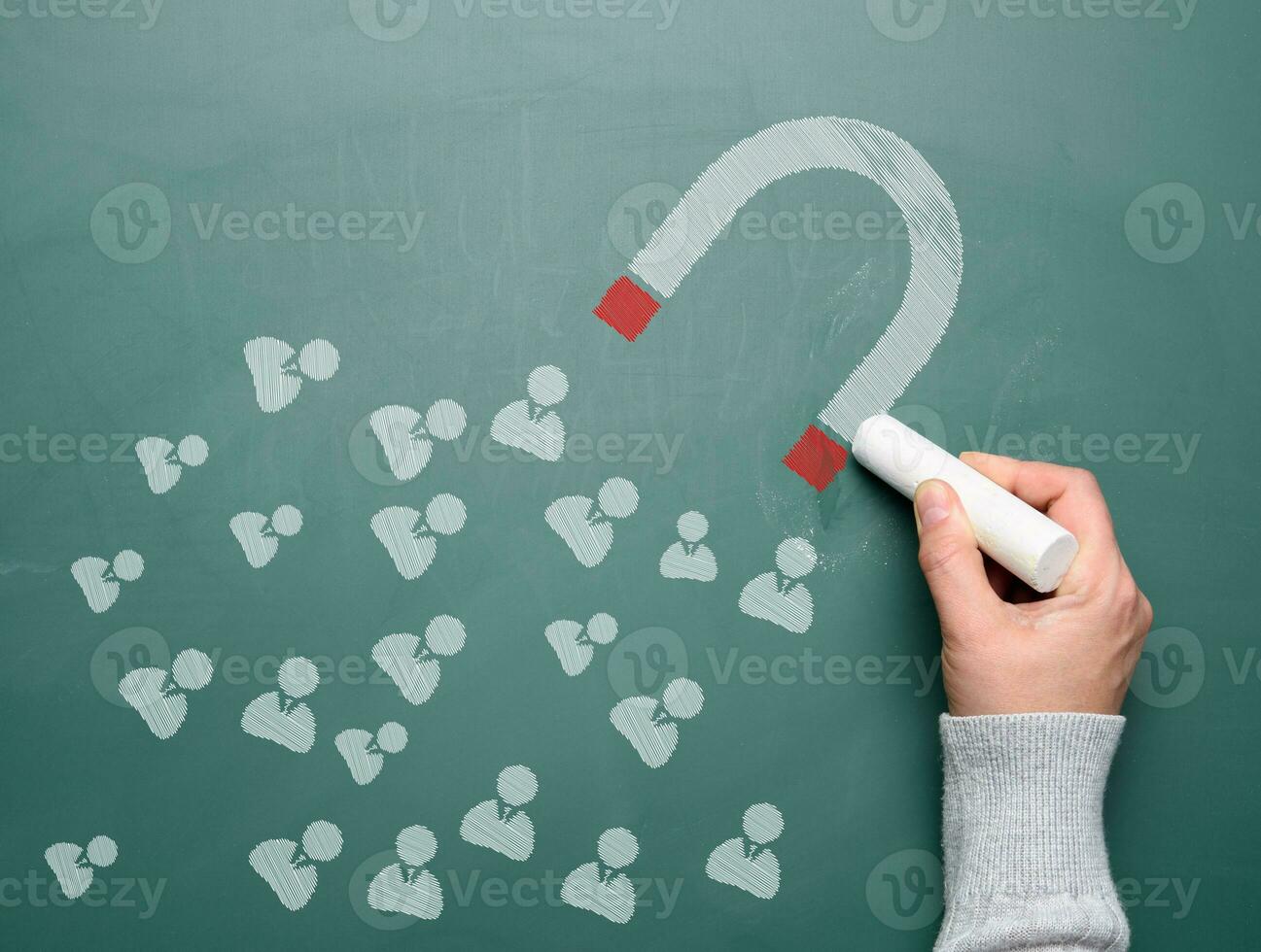 Magnet and icons drawn with white chalk. The concept of attracting new customers and retaining the audience photo
