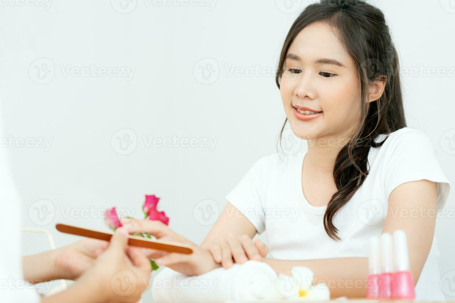 Woman receive care service by professional Beautician Manicure at spa centre. Nail beauty salon use nail file for Glazing treatment. manicurist make nail customer to beautiful. body care spa treatment photo