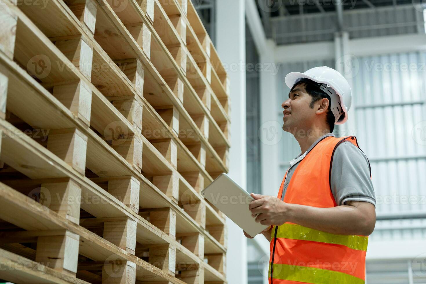 Asian male factory inspect pallet in warehouse or inventory and check stock product. Transport logistic business shipping, delivery to customers. inspection, storehouse, storage, factory photo