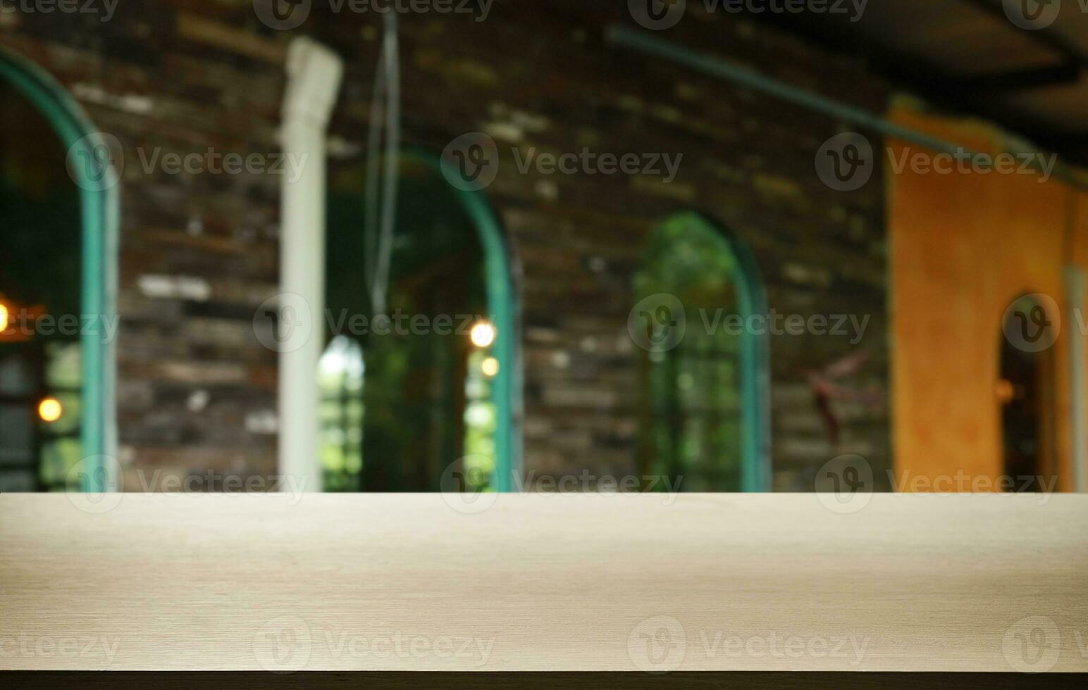 Empty wooden table in front of abstract blurred background of coffee shop . can be used for display or montage your products.Mock up for display of product photo