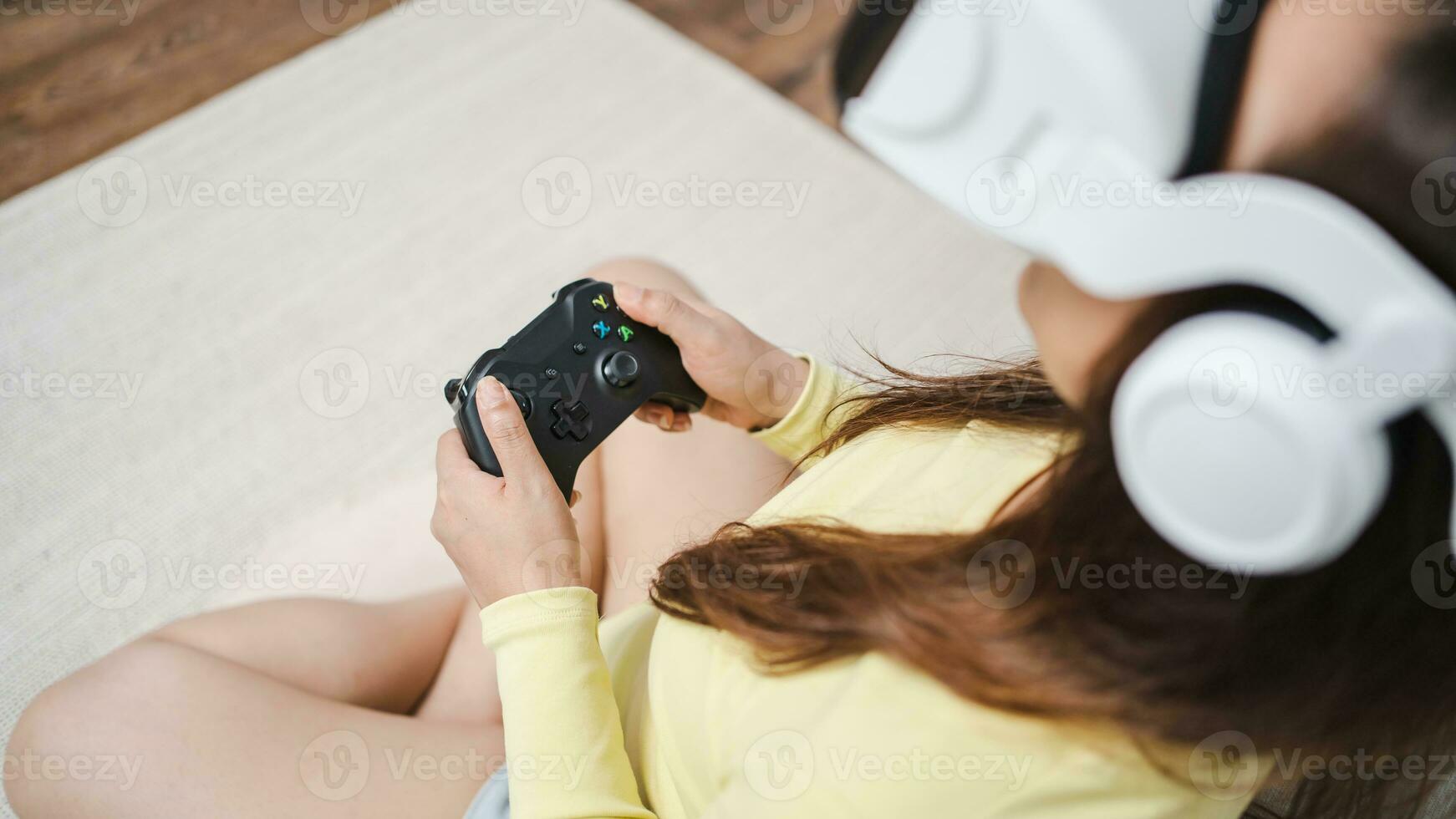 Young Asian woman gamer wearing virtual reality touching air during the VR experience  Future home technology player hobby playful enjoyment concept. photo