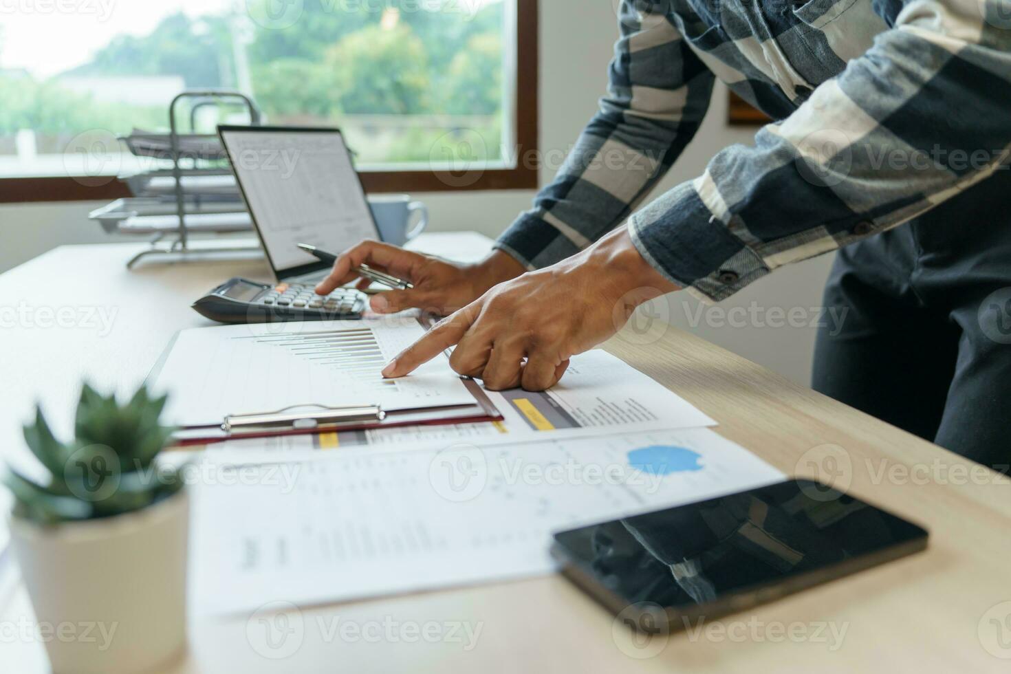 Attractive confident Hispanic Business man using laptop computer and professional working investor start up project business planning in office photo