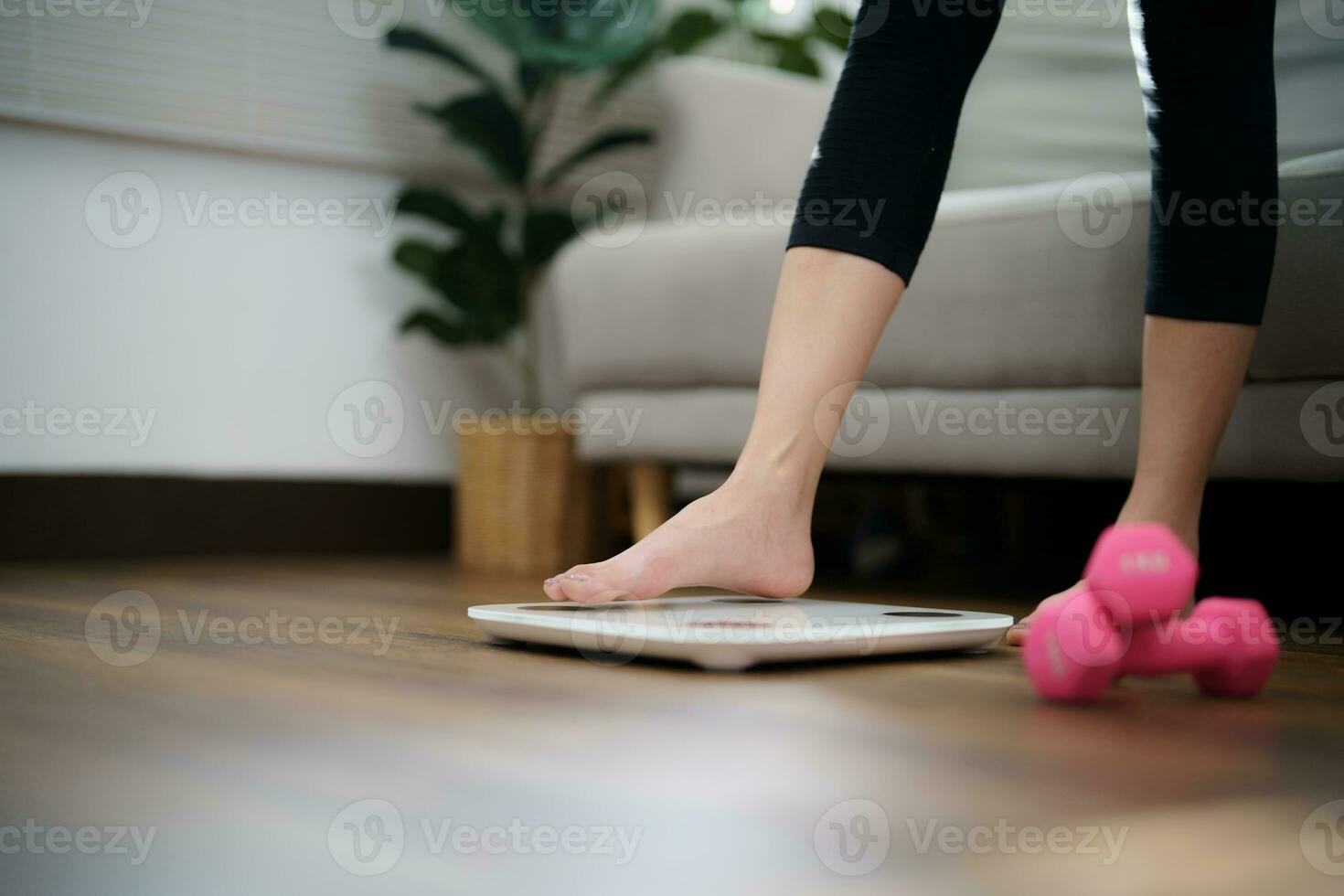 Fat diet and scale feet standing on electronic scales for weight control. Measurement instrument in kilogram for a diet control photo