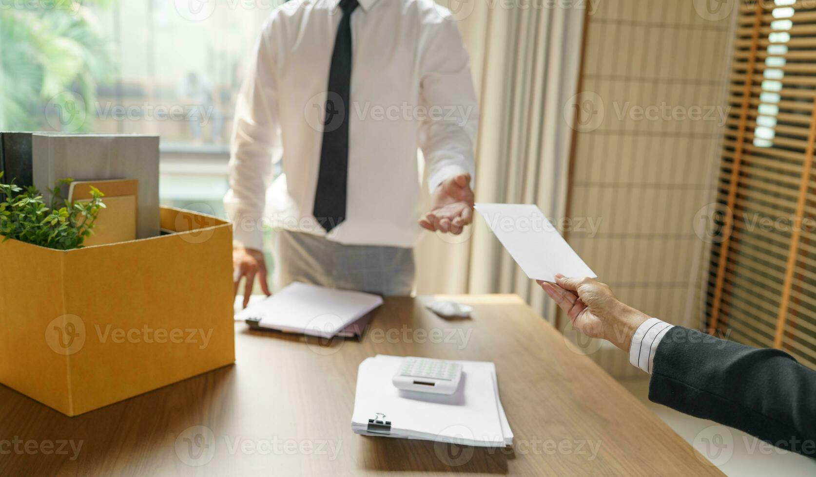 Quit Job Business man sending resignation letter and packing Stuff Resign Depress or carrying business cardboard box in office. Change of job or fired from company. photo