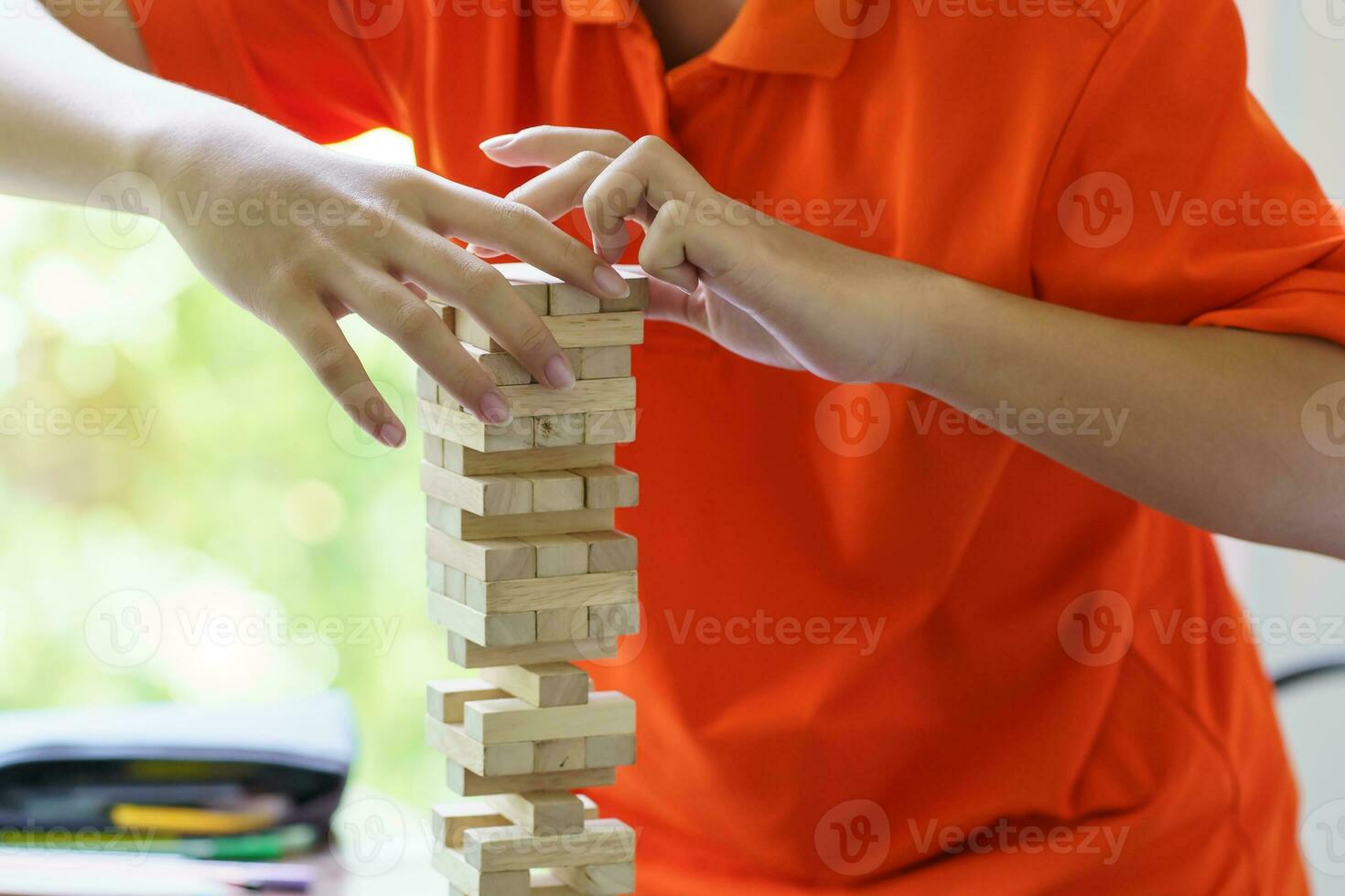 Asian father and son playing wood blocks game Carefree kid playing wood blocks game building constructor from blocks with father at home photo